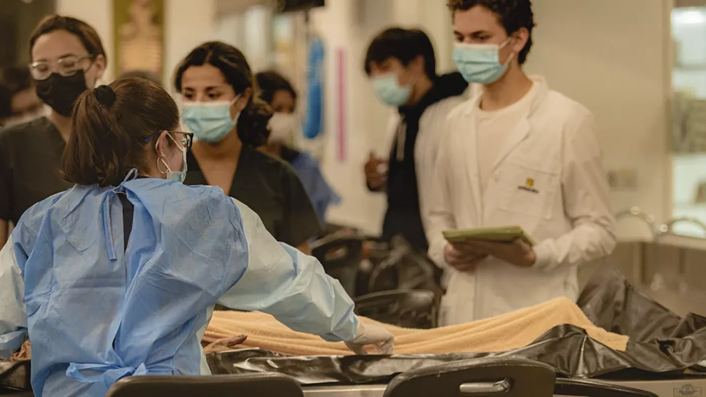 Adriana y estudiantes de medicina en el laboratorio 