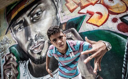 Donny Juan Pablo Lozano, frente a un grafitti en Gramalote