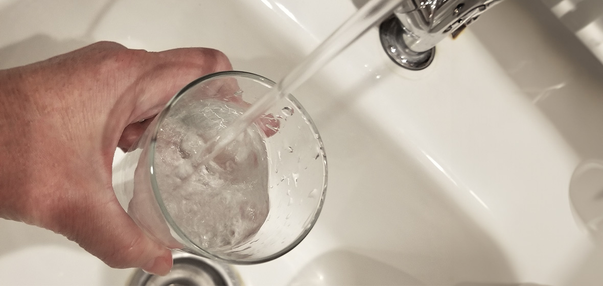 Foto de mano sirviendo una vaso de agua